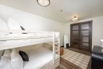 The bunk room is a cozy, inviting space for younger guests.